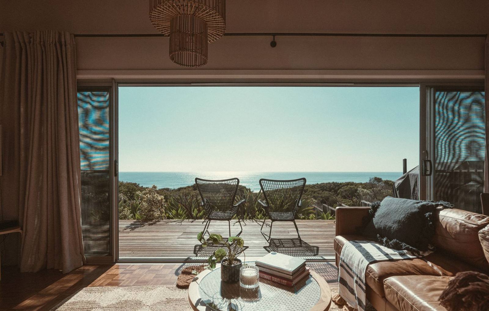 A hotel suite opening onto a terrace above the sea